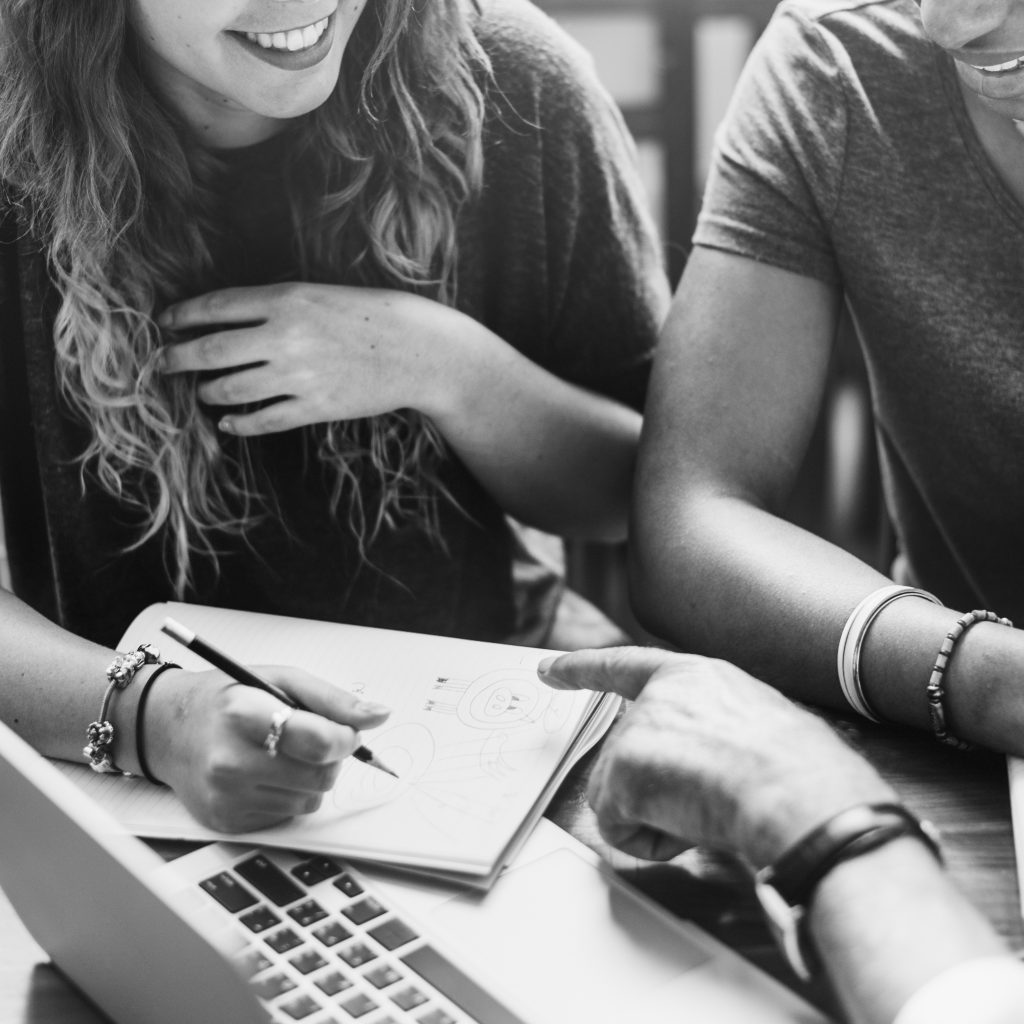 closeup-diverse-group-friends-sitting-together-grayscale